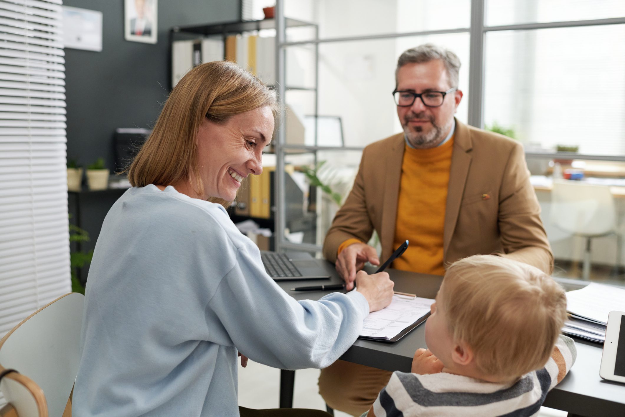 Woman and child talking with a man.